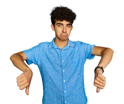 Upset teenage boy with casual clothes and wavy black hair frowning sulking sad, disappointed, show thumbs-down grimacing, give negative opinion, judging transparent background