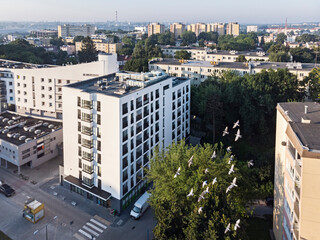 Widok z lotu ptaka na panoramę miasta i osiedli w Lublinie. Nowoczesny budynek z duża ilością...