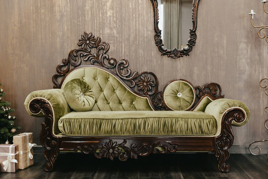 Luxurious interior in vintage style. Classic living room interior with sofa, pillows and mirror.