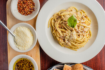 Spaghetti carbonara. Pasta with cured pork, cheese, egg, bacon, pepper and Italian parsley. Classic American or Italian restaurant favorite. Homemade pasta with butter sauce, meat and cheese.