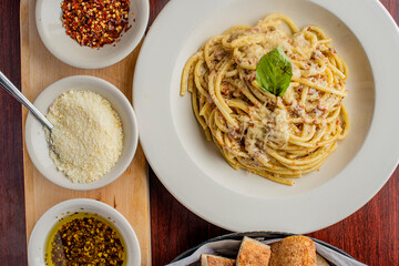 Spaghetti carbonara. Pasta with cured pork, cheese, egg, bacon, pepper and Italian parsley. Classic American or Italian restaurant favorite. Homemade pasta with butter sauce, meat and cheese.