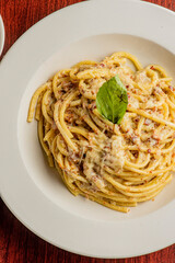 Spaghetti carbonara. Pasta with cured pork, cheese, egg, bacon, pepper and Italian parsley. Classic American or Italian restaurant favorite. Homemade pasta with butter sauce, meat and cheese.