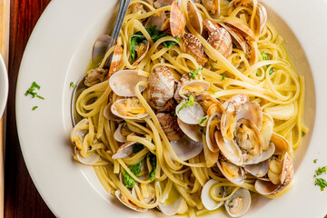 Pasta with clams. Pasta with clams and seafood, Parmesan cheese, spinach, and Italian parsley. Classic American or Italian restaurant favorite. Homemade pasta with tomato sauce, meats and cheeses.