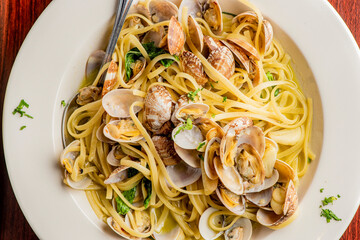Pasta with clams. Pasta with clams and seafood, Parmesan cheese, spinach, and Italian parsley. Classic American or Italian restaurant favorite. Homemade pasta with tomato sauce, meats and cheeses.