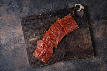 Homemade beef and pork jerky on cutting board