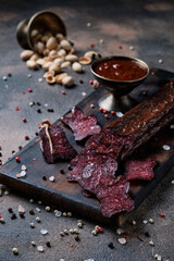 Traditional smoked salami sausage with spices.Salami sausage slices on a wooden chopping board