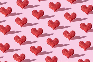 Fototapeta na wymiar Pattern with red glitter heart shape on pink background with hard shadow. Valentines day minimalistic symbol love