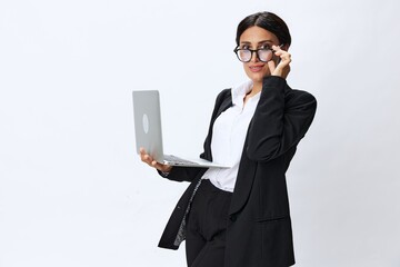 Business woman with laptop in hand in black business suit shows signals gestures and emotions on white background, freelancer job online training