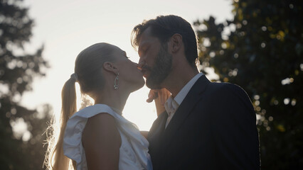 Portrait of charming man and woman newlyweds outdoors. Action. Happy wedding couple in summer...