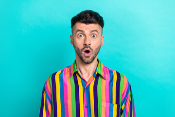 Photo of impressed excited funny man with brunet hair dressed striped shirt open mouth staring...