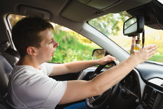 Novice driver sitting in his car behind the wheel shaking threatens another motorist. Bad and aggressive behavior on road concept.