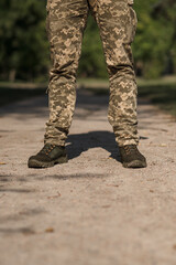 A military man in a special uniform and protective tactical sneakers. Special waterproof sneakers...