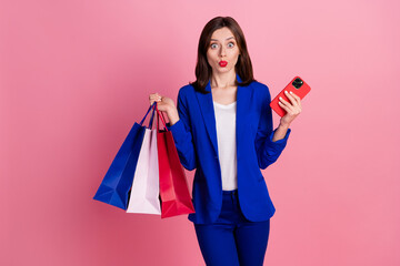 Photo of astonished pretty lady wear blue stylish suit wait order courier delivery service empty space isolated on pink color background