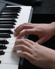 Music playing practice. Two hands on the piano keyboard. Notes chords and scales close-up