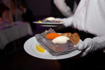 Starter with roe garlic and cream served on an ice plate 