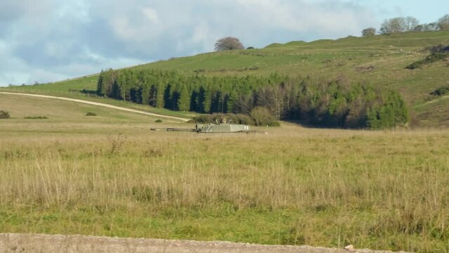 British army FV4034 Challenger 2 ii main battle tank driving across a grass meadow on a military combat exercise, Wiltshire UK