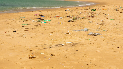 Beach sand and ocean with so many garbage plastic pollution in Senegal