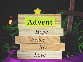 Advent hope peace joy love text on wooden blocks with vintage background. Christmas celebration preparation concept. 