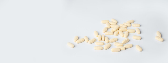 Close-up of drugs, pills, tablets, vitamins, food addictive in season of colds and flu over white...