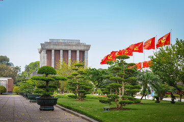 communist flag of Vietnam fluttering on the background of the mausoleum of Ho Chi Minh