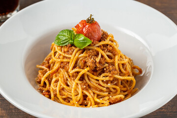 Spaghetti with bolognese sauce on a white porcelain plate