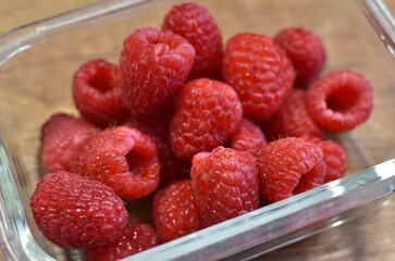 raspberries on a wooden brown table