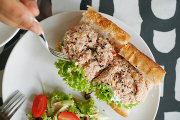Tuna sandwich with mayonnaise on a plate on table 