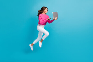 Full length photo of charming sweet lady wear pink preparing tasks modern gadget jumping high...