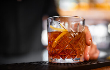 man hand bartender hold cocktail glass in bar