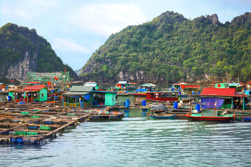 floating fishing village between the rocky islands of halong bay