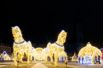 Scenic art light led lamp decoration figures of horse carriage, christmas tree bowl on Magdeburg Dom square. Light world lichterwelt city new year xmas in Germany Saxony-Anhalt - obrazy, fototapety, plakaty