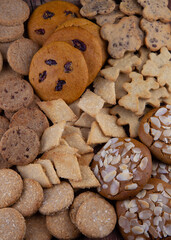 Cookies background. A set of different cookies. Cookies with almonds, coconut, chocolate, spelled, raisins. Homemade simple pastries. Sweet food concept
