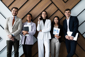 Portrait of successful creative business team looking at camera and smiling. Diverse business people standing together at startup.