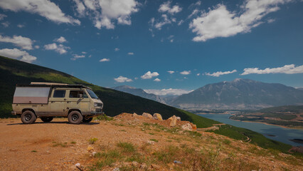Adventure oldtimer van or camper, campervan on high plain with good view panorama of city Kukes in...
