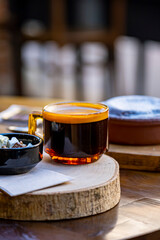 Cup of espresso coffee on decorative wood. Cafe environment restaurant table.
