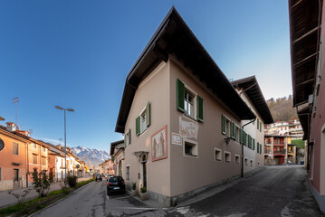Boves, Italy - November 22, 2022: Corso Bisalta and via Sant Antonio and Castle street with the typical eighteenth-century houses with frescoes, Mount Bisalta in the background