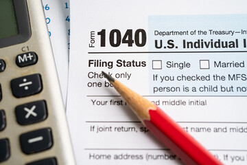 Tax Return form 1040 with USA America flag and dollar banknote, U.S. Individual Income.