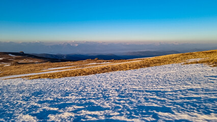 Scenic view of snow covered alpine meadows and Karawanks mountains seen from Ladinger Spitz,...