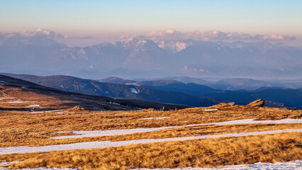 Scenic view of snow covered alpine meadows and Karawanks mountains seen from Ladinger Spitz,...