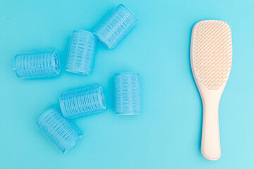 Blue hair curlers on a blue background