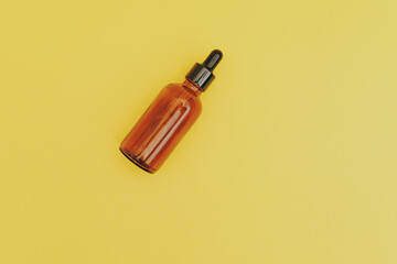 Serum bottle on yellow background