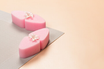 Pink facial sponges with hyacinth flower. Cosmetic sponge for applying foundation on the face.