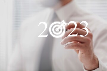 Hand touch in target with 2023 numbers