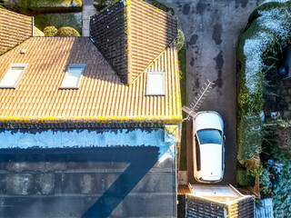 Drone top down view of a bungalow with a recent first floor conversation showing its flat roof....