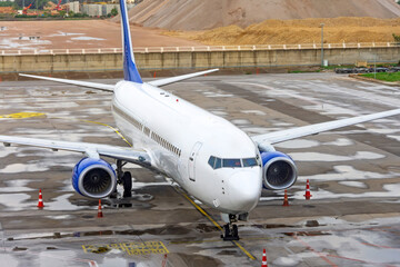 Passenger plane parked at the airport after rain.