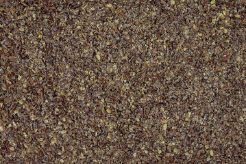 the natural raw broken flax seeds, linseeds (Linum usitatissimum)