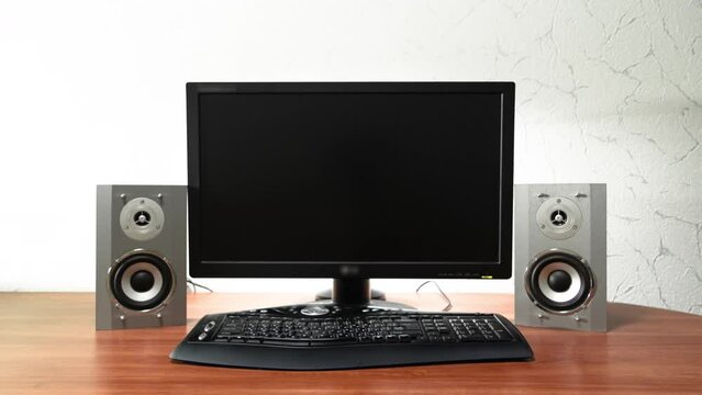 Work desk for digital job with computer, audio speakers and keyboard timelapse hyperlapse. Forward motion to the screen turning off and swithcing to black monitor