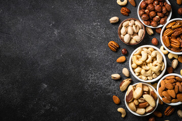 Assortment of nuts in bowls. Cashew, hazelnuts, pecan, almonds, brazilian nuts and pistachios.