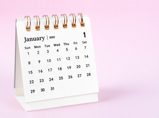 Fototapeta na wymiar A January 2023 desk calendar on pink color background.