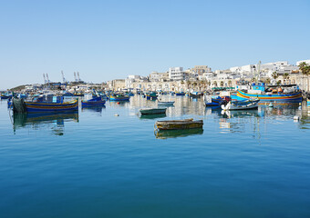 Fototapeta na wymiar Panorama of fishing boats in european Marsaxlokk town in Malta